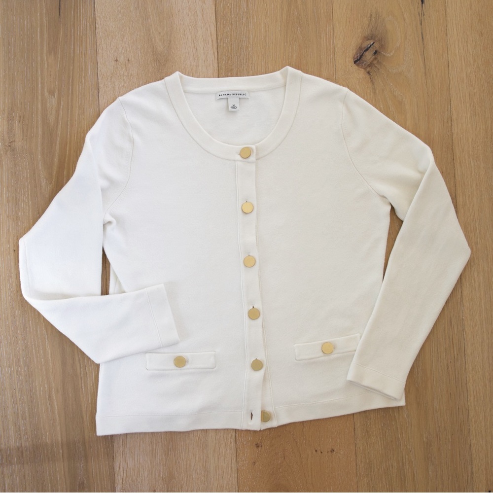 Cream-colored waist length knit cardigan jacket by Banana republic.
